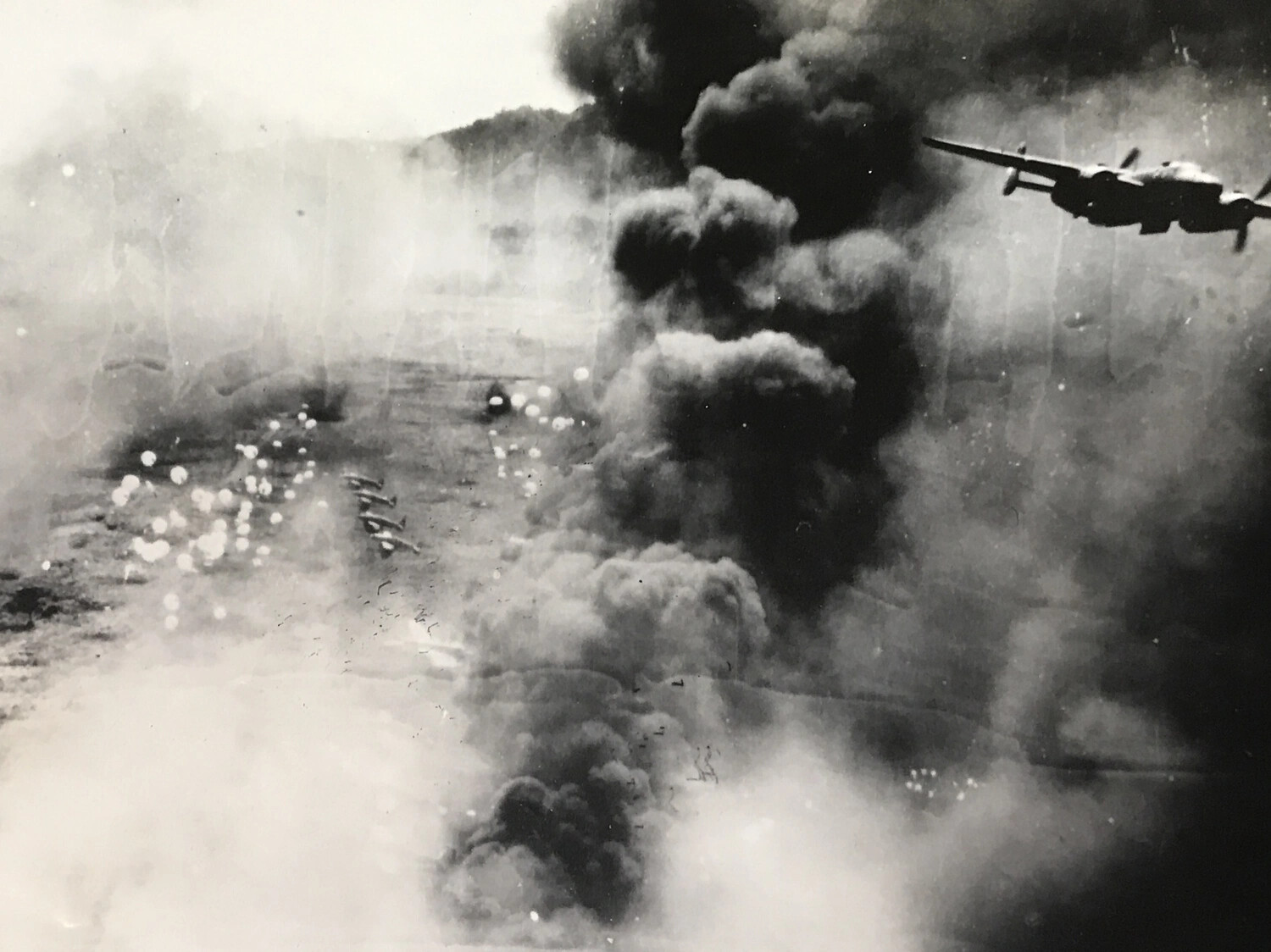 Close Aerial View: B-25 Mitchell Banking Away from Smoke Column, Dagua Airfield Raid