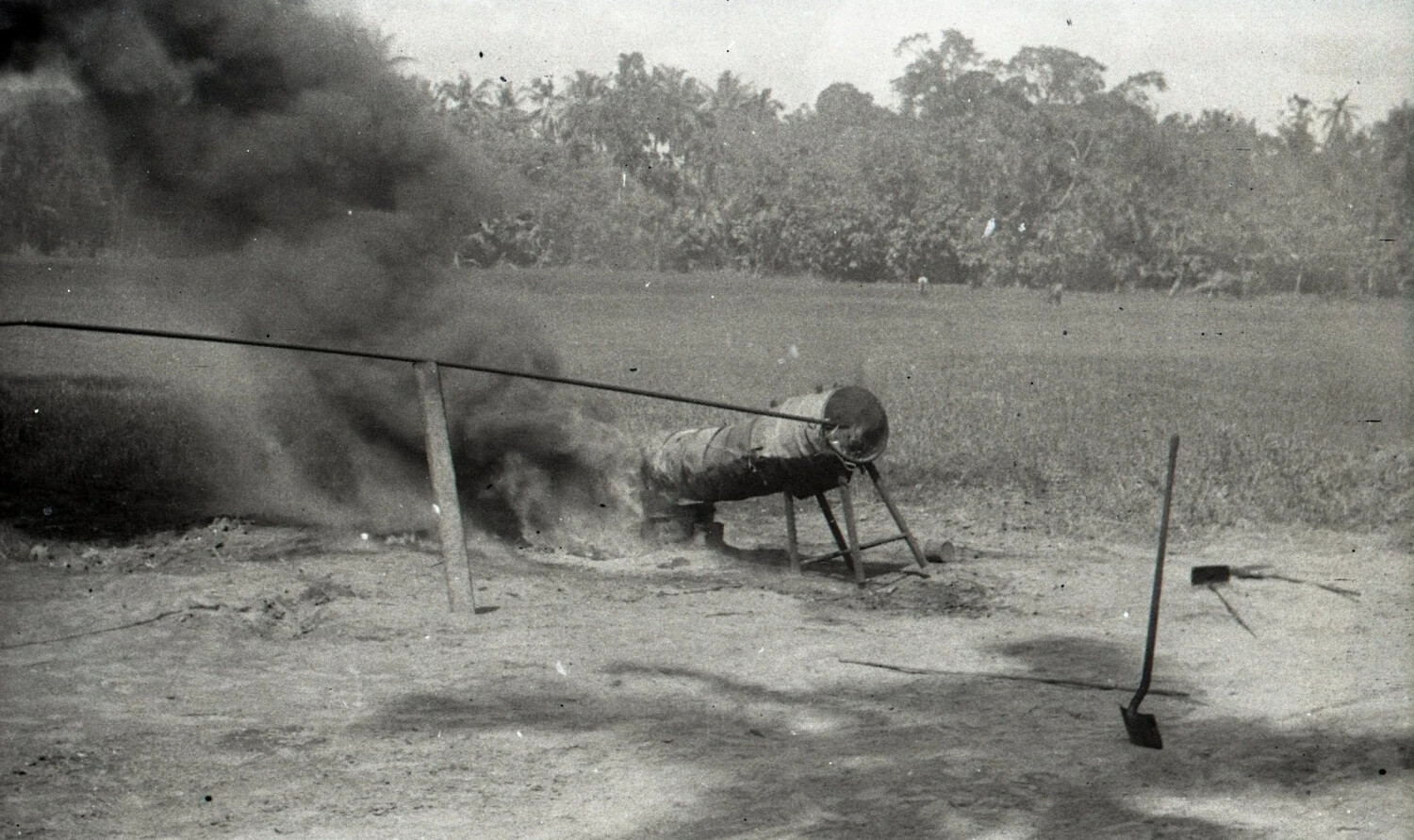Smoking Field Incinerator or Immersion Water Heater in Operation, Luzon, Philippines, WWII Era