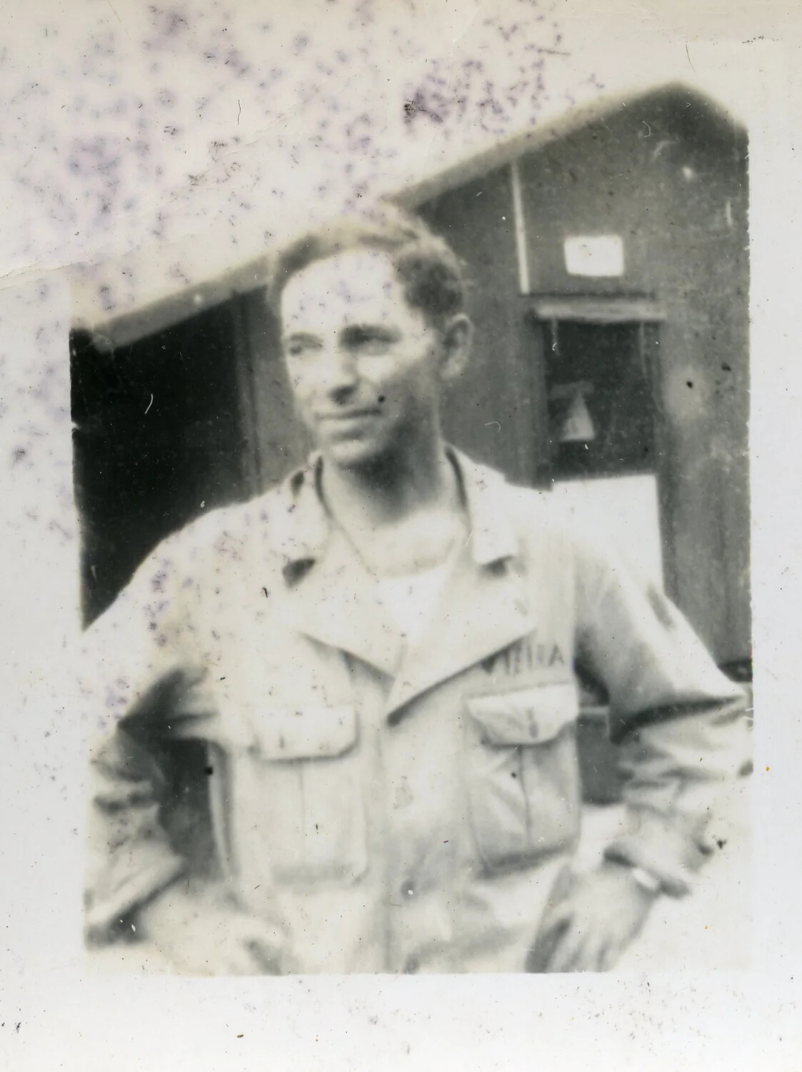 Portrait of Serviceman Stenciled 'Vieira' in Front of Barracks Hut, World War II Era