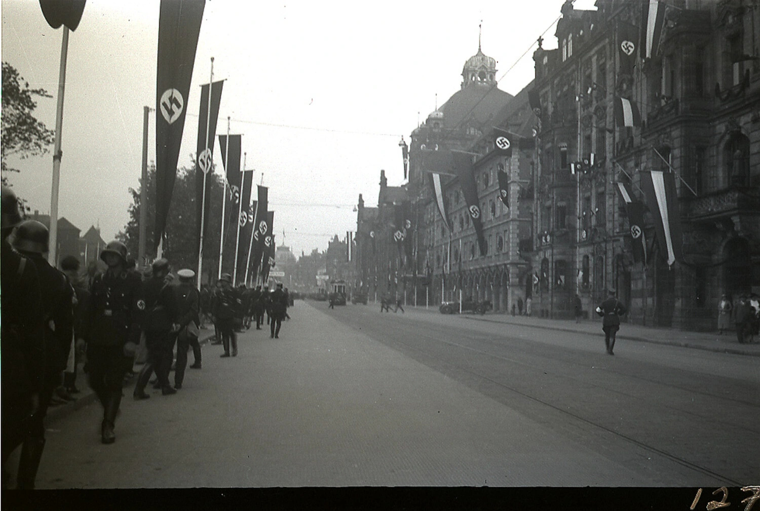 German Soldiers Marching Past Flag-Draped City Hall After Parade, WWII Era