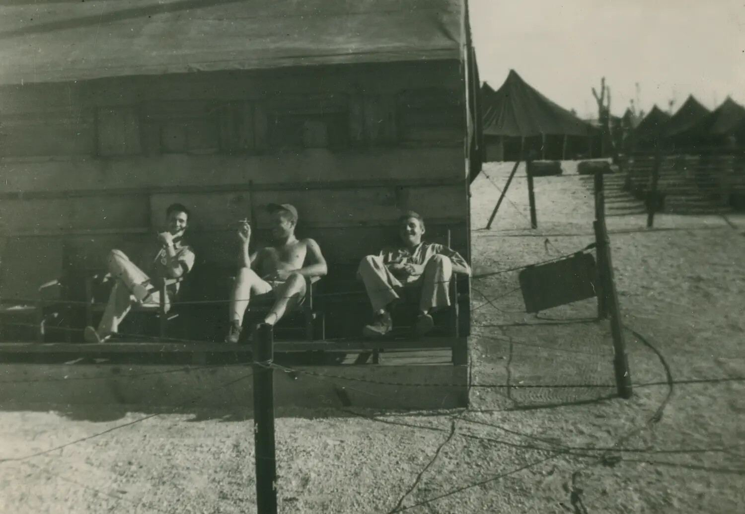 Servicemen Relaxing on Tent Platform at Camp, Edward P. McAleer WWII Album