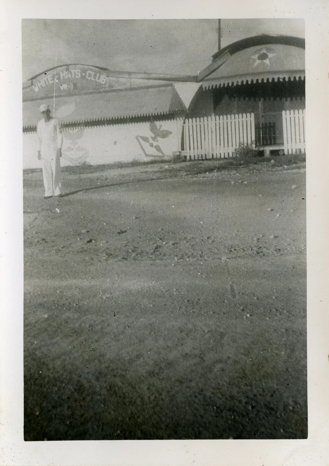 Sailor Outside the 'White Hats Club' Quonset Hut, US Naval Air Transport Squadron, Guam