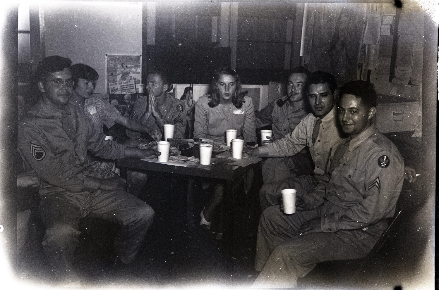 Servicemen and Guest Gathered Around a Table in Squadron Day Room