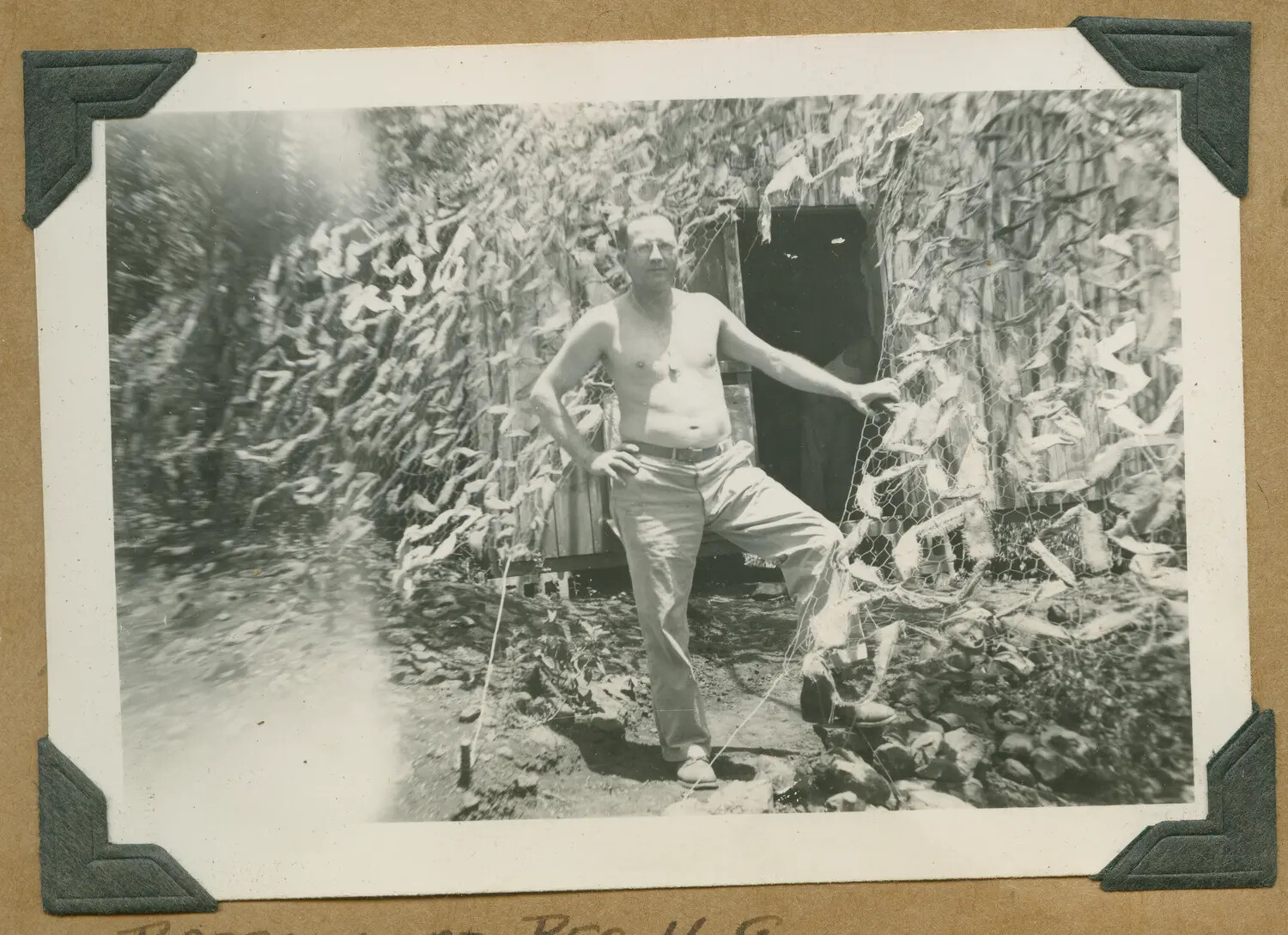 Soldier at Entrance of Camouflage-Netted Field Shelter, 'Barracks at Regimental H.Q.,' Hawaii, c. 1942