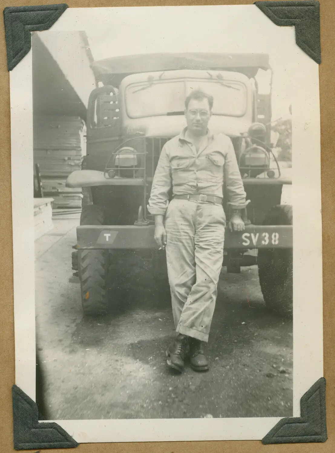 Serviceman Beside Military Truck with Bumper Code "SV 38," Hawaii, World War II Era