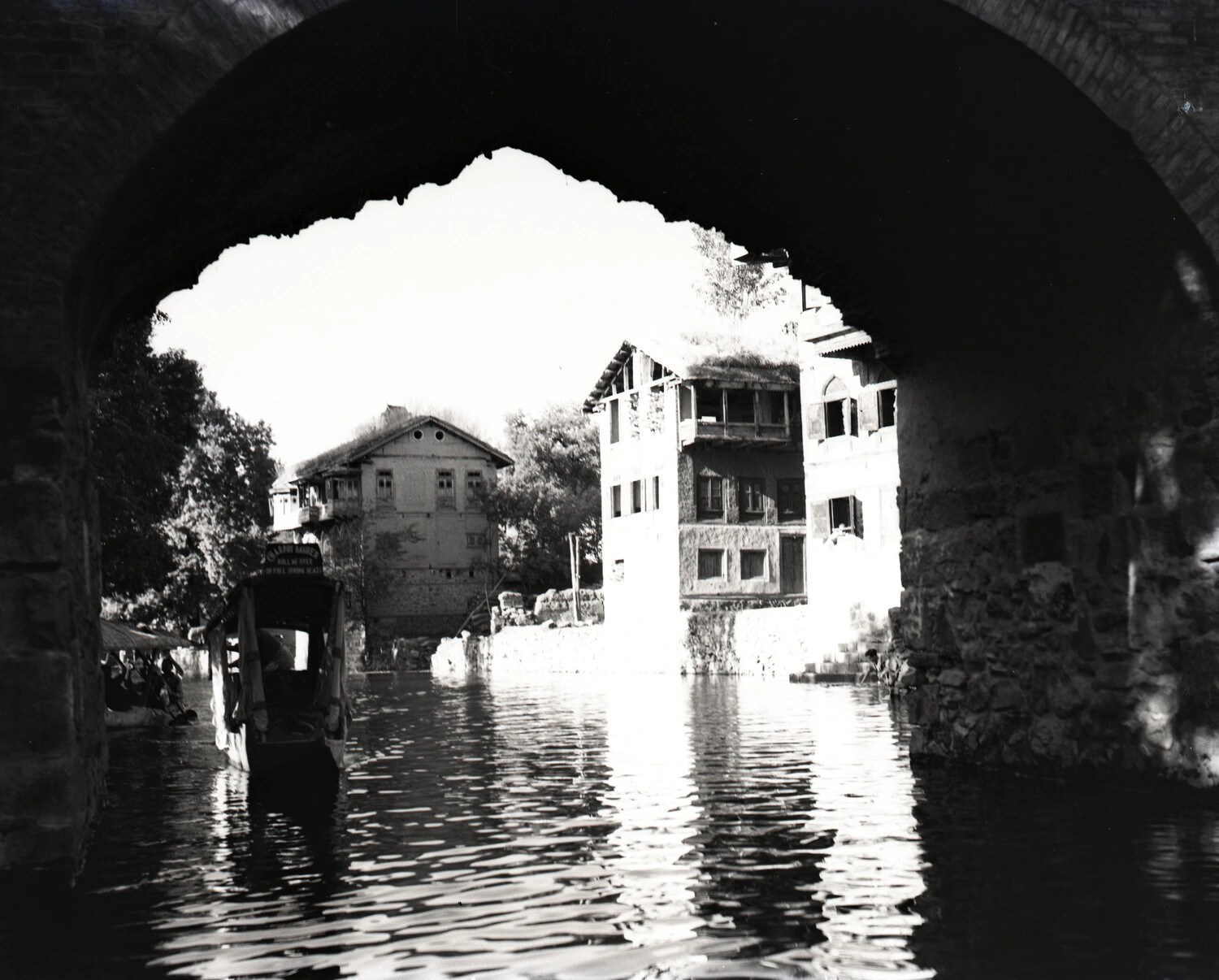 View Through Stone Bridge Arch of Riverside Buildings and Boat, Likely Srinagar, Kashmir, India, WWII CBI Theater