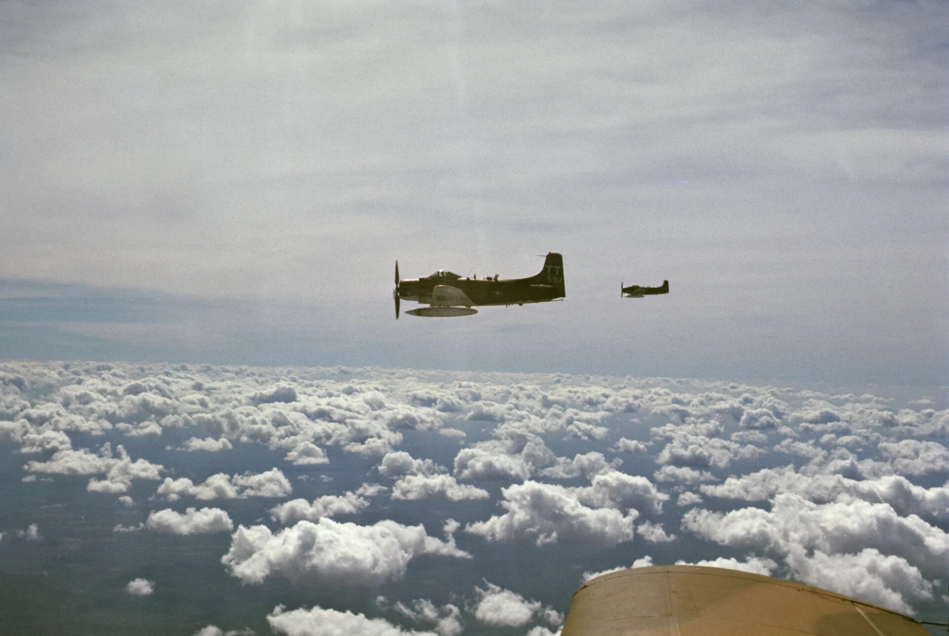 A-1 Skyraider 'TT-593' in Formation Above Cloud Deck