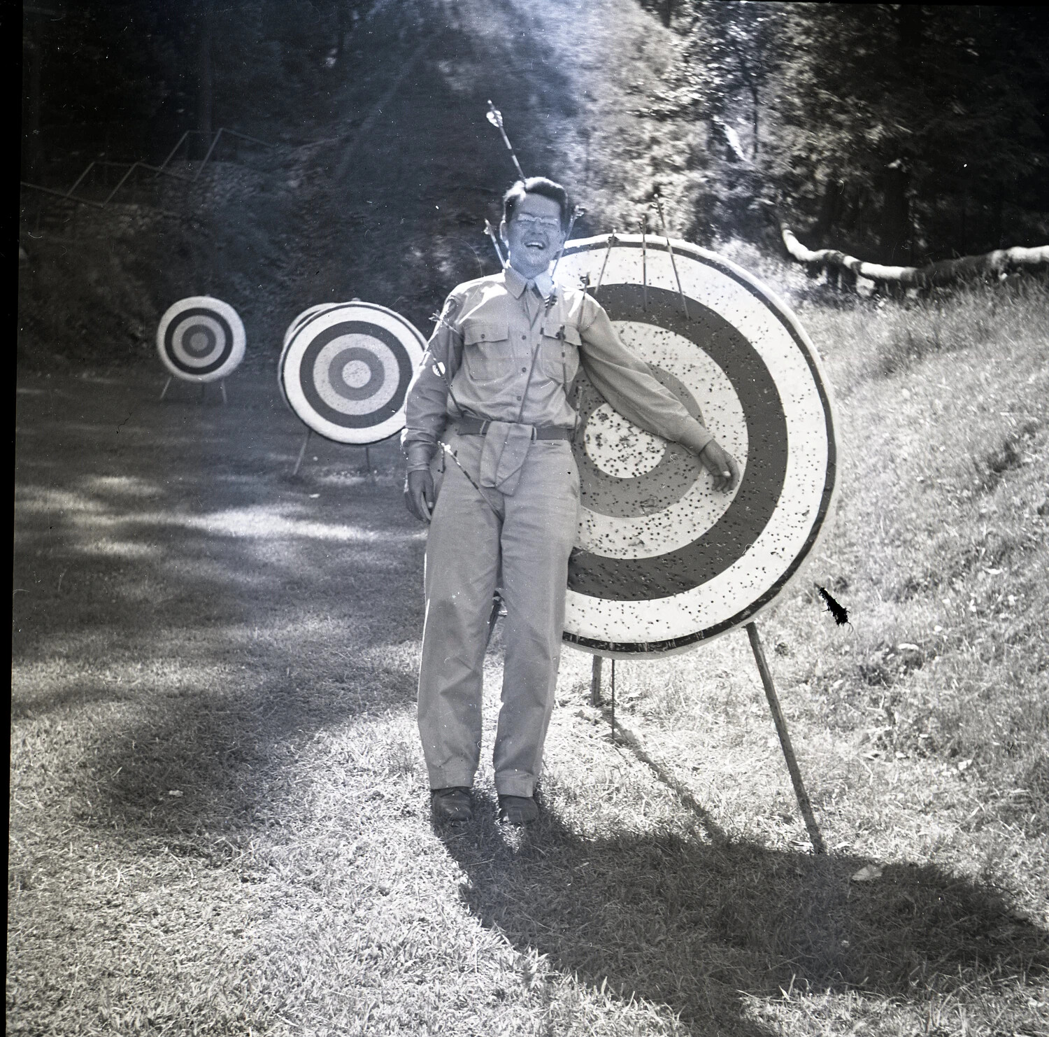 Man Posing Comically with Arrows at an Outdoor Archery Range