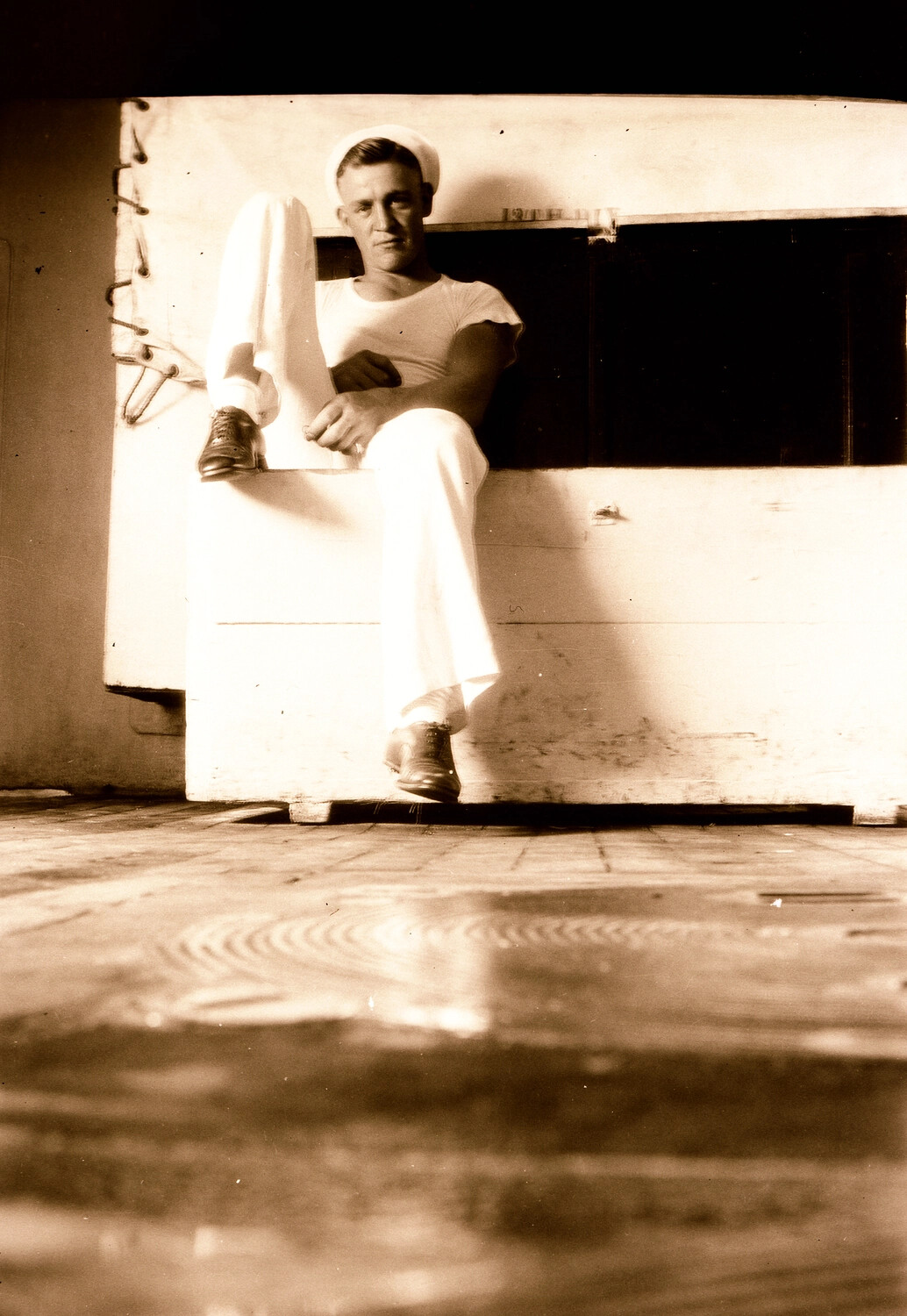 U.S. Navy Sailor Seated on Canvas-Covered Deck Gear, China Station, 1930s
