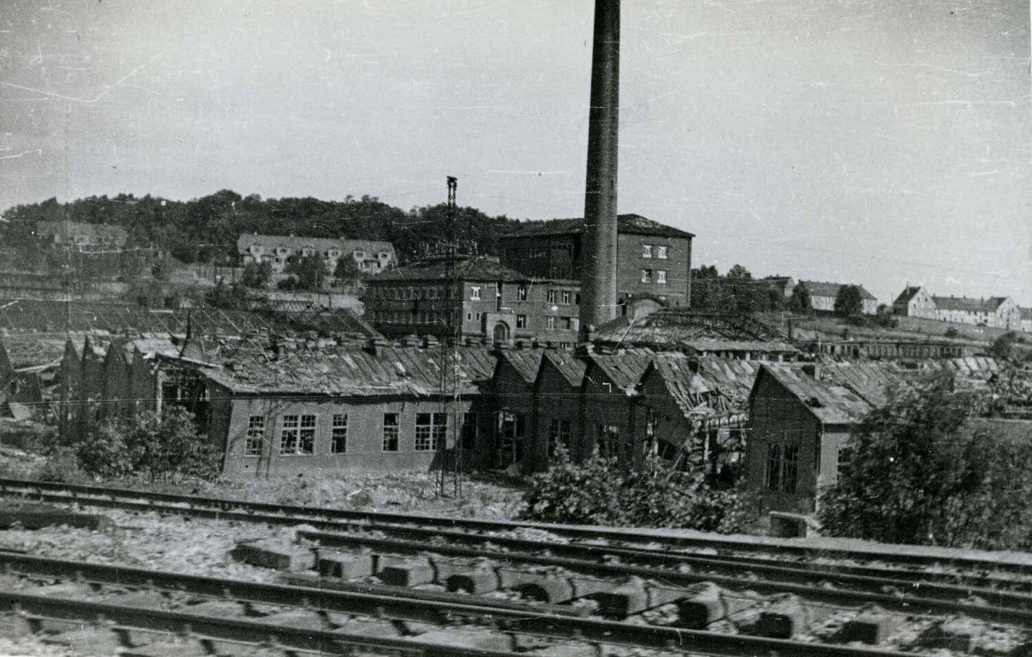 German Industrial Factory Complex with Smokestack and Sawtooth-Roofed Workshops, WWII