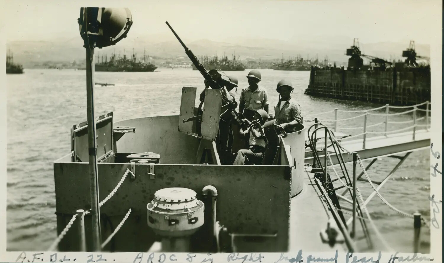 Sailors at 20mm Oerlikon Gun Mount with Pearl Harbor in Background, 1945