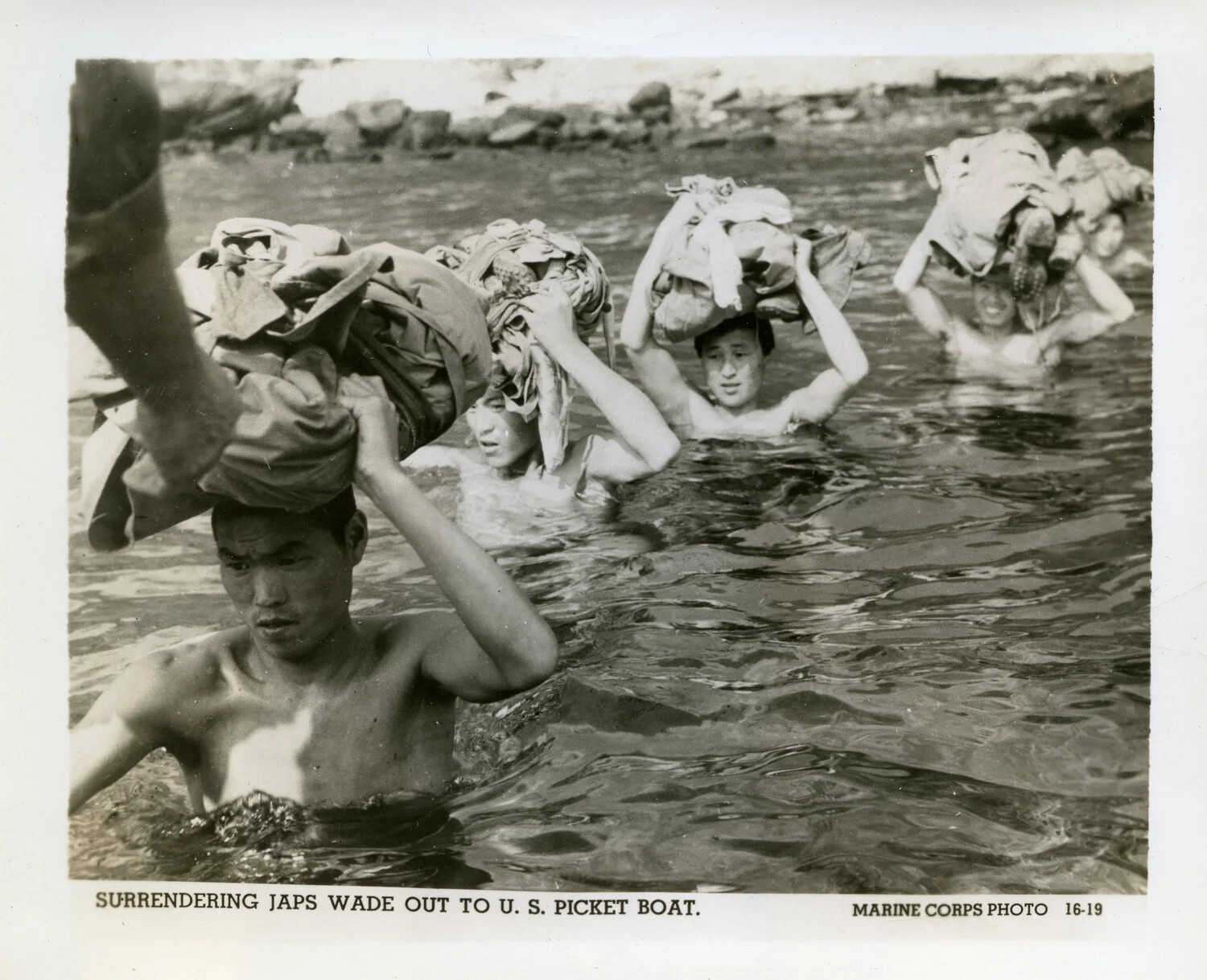 "Surrendering Japs Wade Out to U.S. Picket Boat" -- Official U.S. Marine Corps Photograph, Okinawa Campaign, 1945