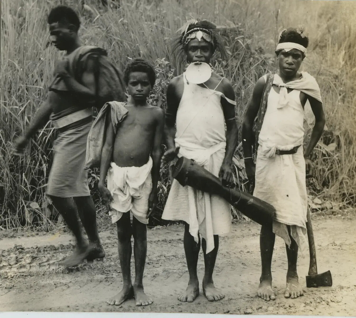Group Portrait of New Guinea Villagers with Traditional Ornaments and Salvaged Metal Object