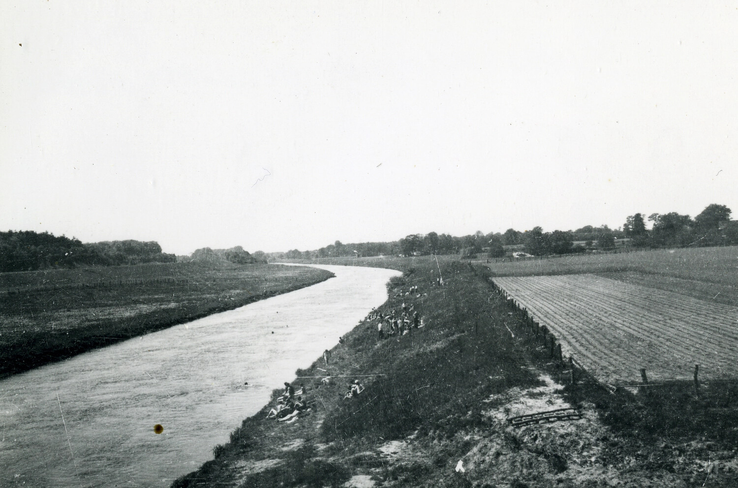 Soldiers Resting Along a Riverbank in the European Countryside, WWII Era