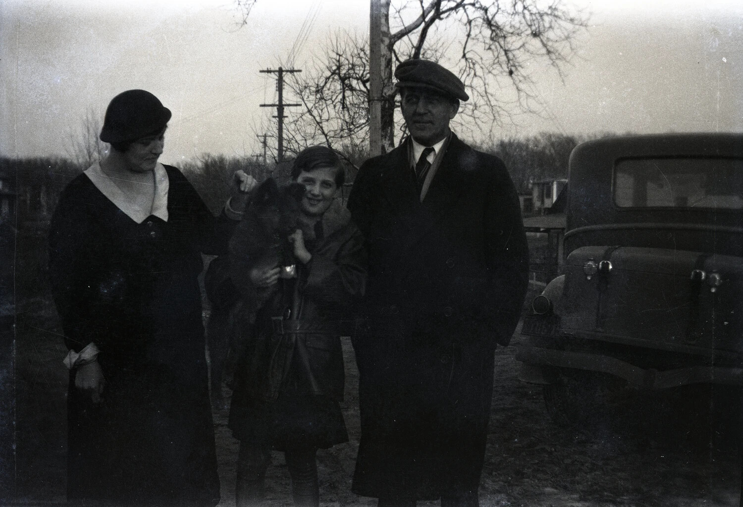 Group Portrait of Three Civilians Beside an Automobile, Rural Setting