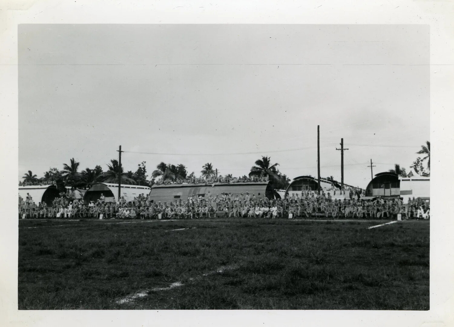 Sailors Watching a Sporting Event at a Quonset Hut Camp, NATS VR-6, Agana, Guam, WWII