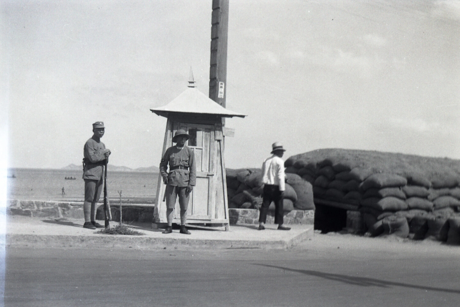 Sentry Post and Sandbagged Bunker at a Chinese Coastal Checkpoint, WWII Era