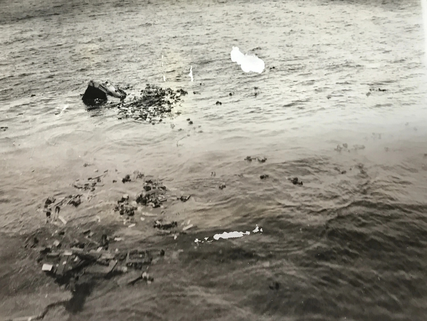 Strike Photograph: Wreckage and Debris from Sunk Japanese Vessel, Muschu Island Area, New Guinea