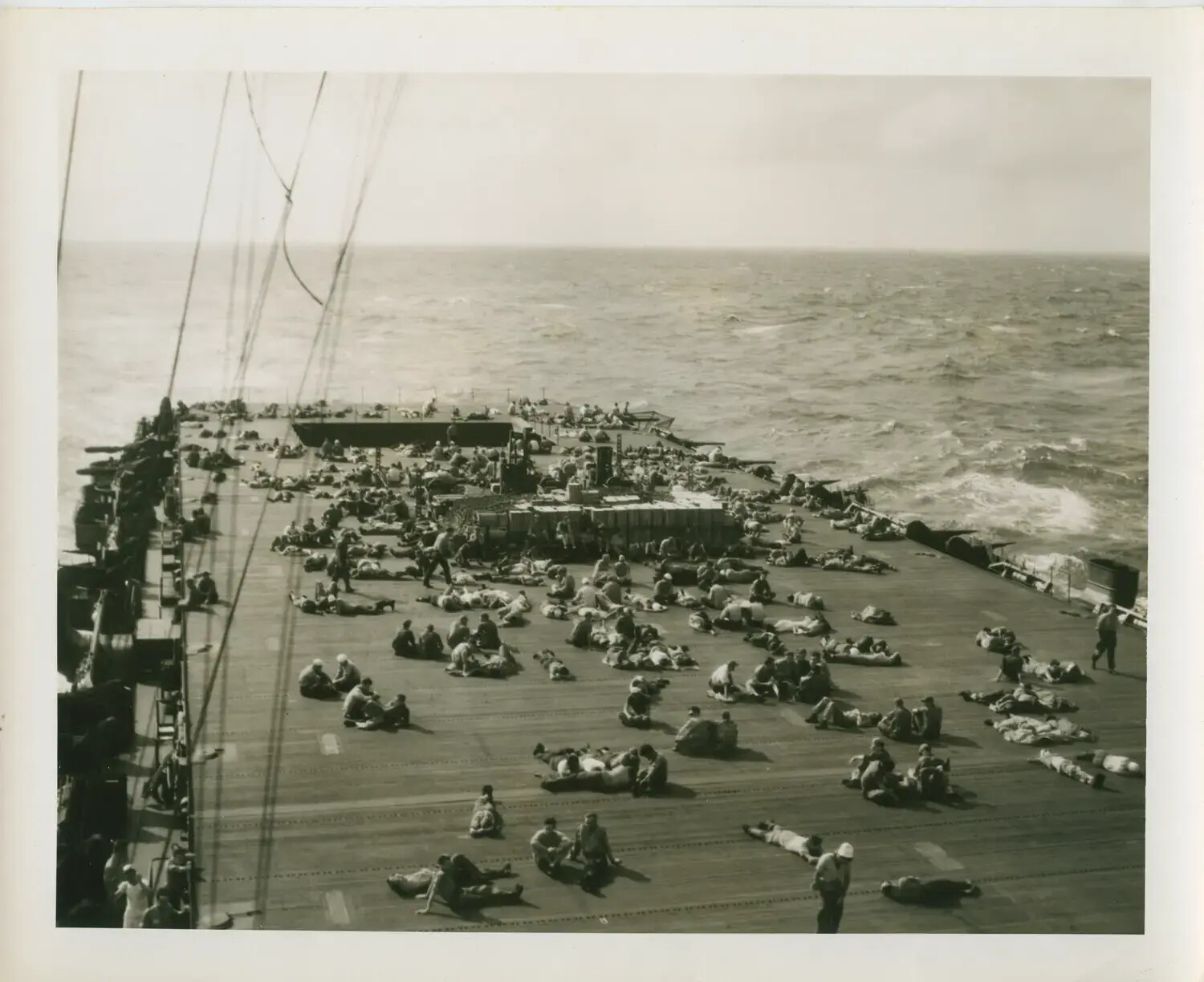 Sailors Resting on the Flight Deck, USS Petrof Bay (CVE-80), World War II Pacific Theater