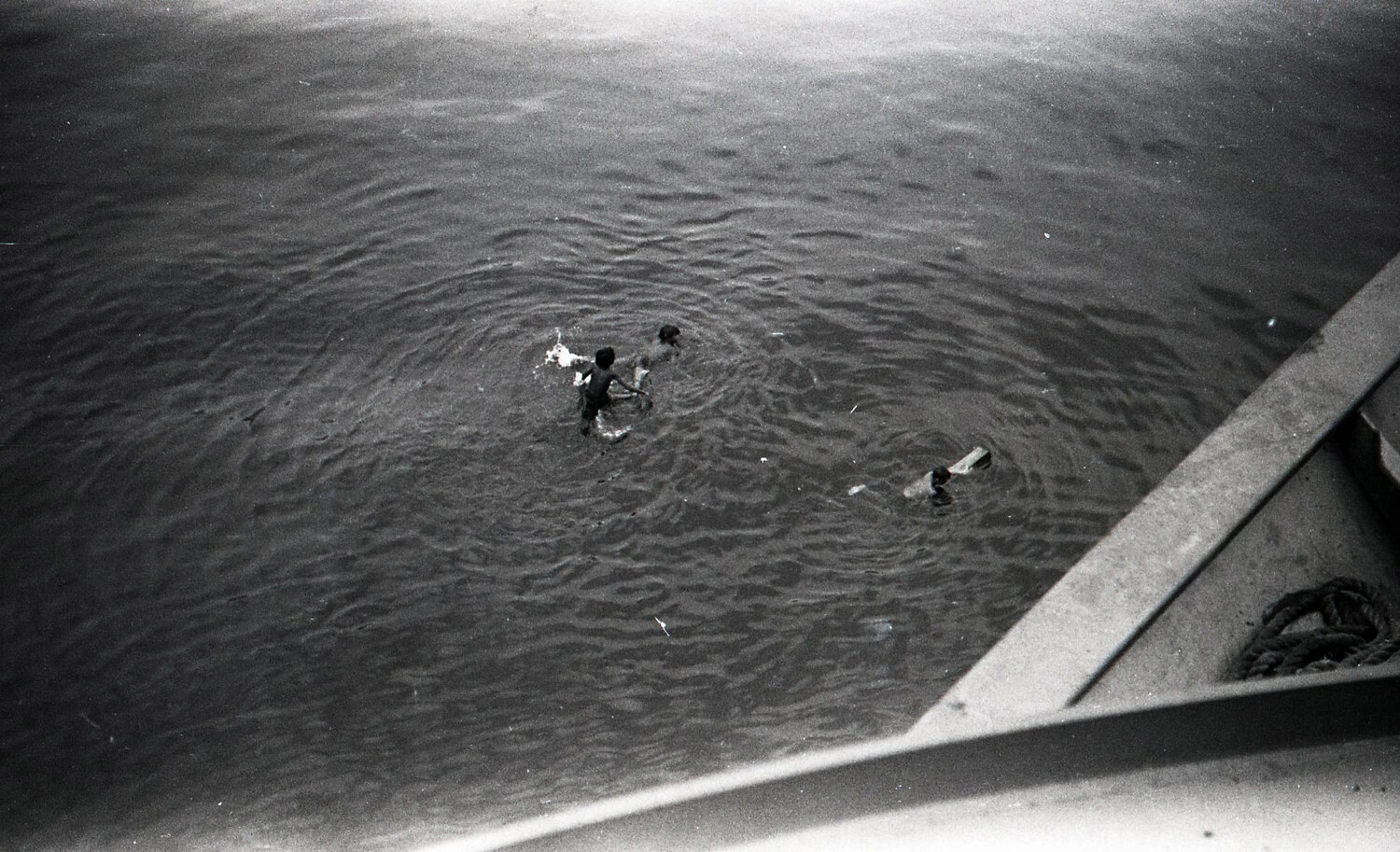 Filipino Boys Swimming Alongside Moored Ship in Manila Harbor, Philippines, 1945