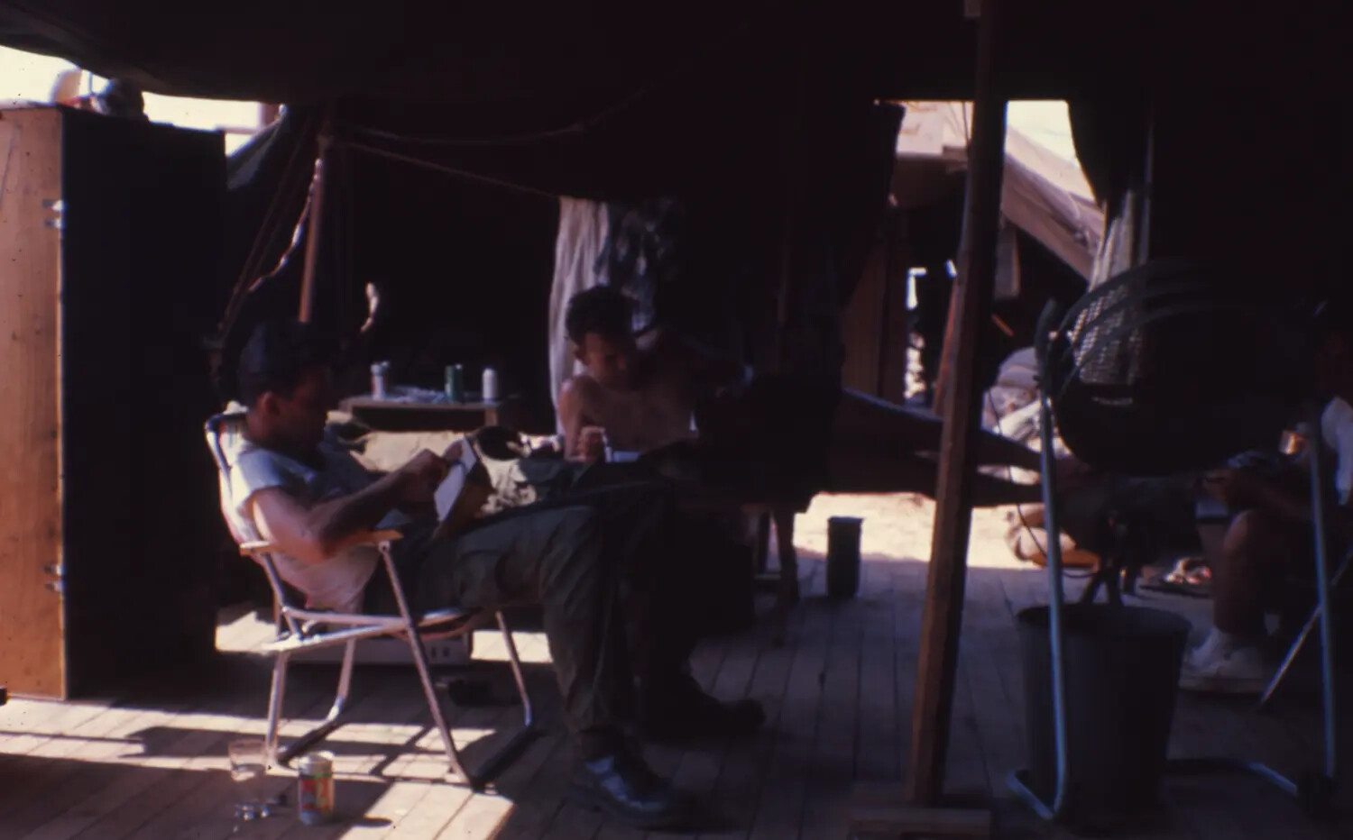 Servicemen Relaxing in Hooch Interior with Folding Chairs and Fan, Cam Ranh Bay, Vietnam