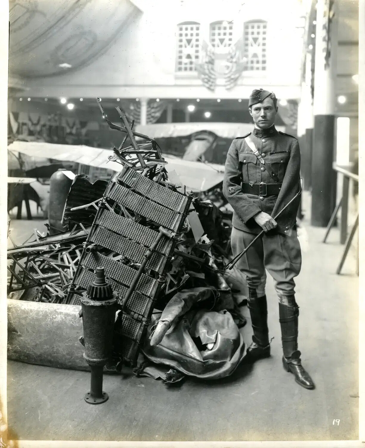 Soldier Beside Wrecked Aircraft Wreckage Pile at WWI Trophy Exhibition Hall