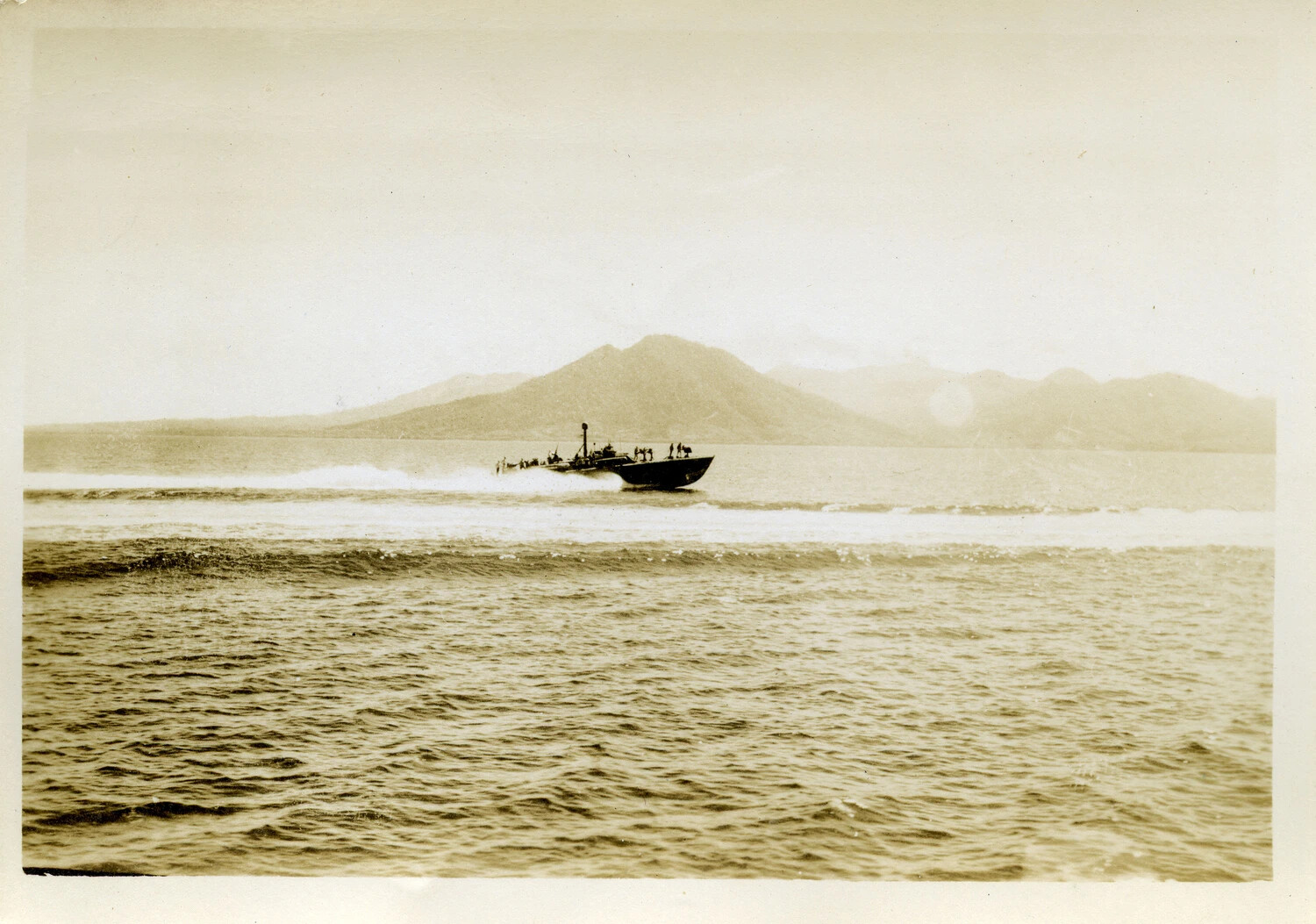 U.S. Navy Motor Torpedo (PT) Boat Underway Off a Pacific Volcanic Island, WWII