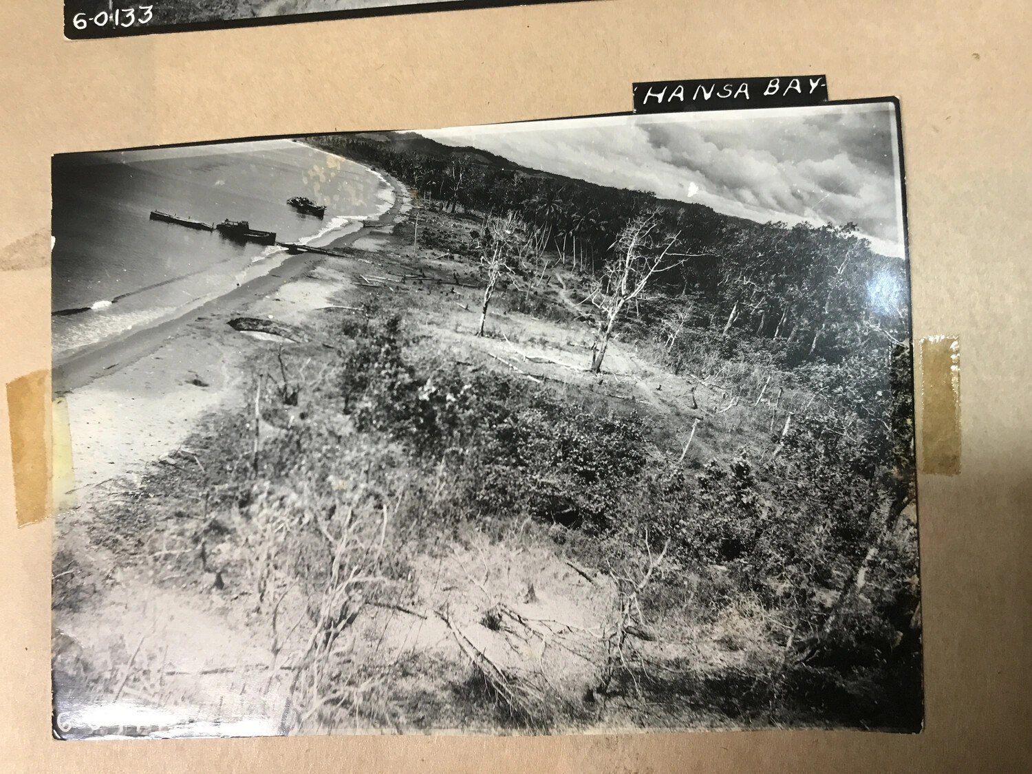 Album Page: Aerial Photograph of Defoliated Hansa Bay Shoreline with Original Label
