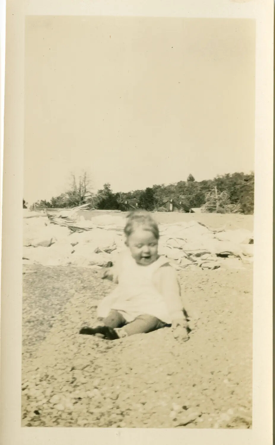 Snapshot of a Toddler on a Pebble Beach, Family Photo Album (Mislabeled WWII Folder)