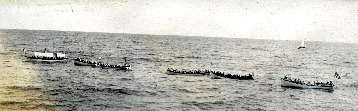 Steam Launch Towing a String of Manned Ship's Boats at Sea - USS Columbia Album