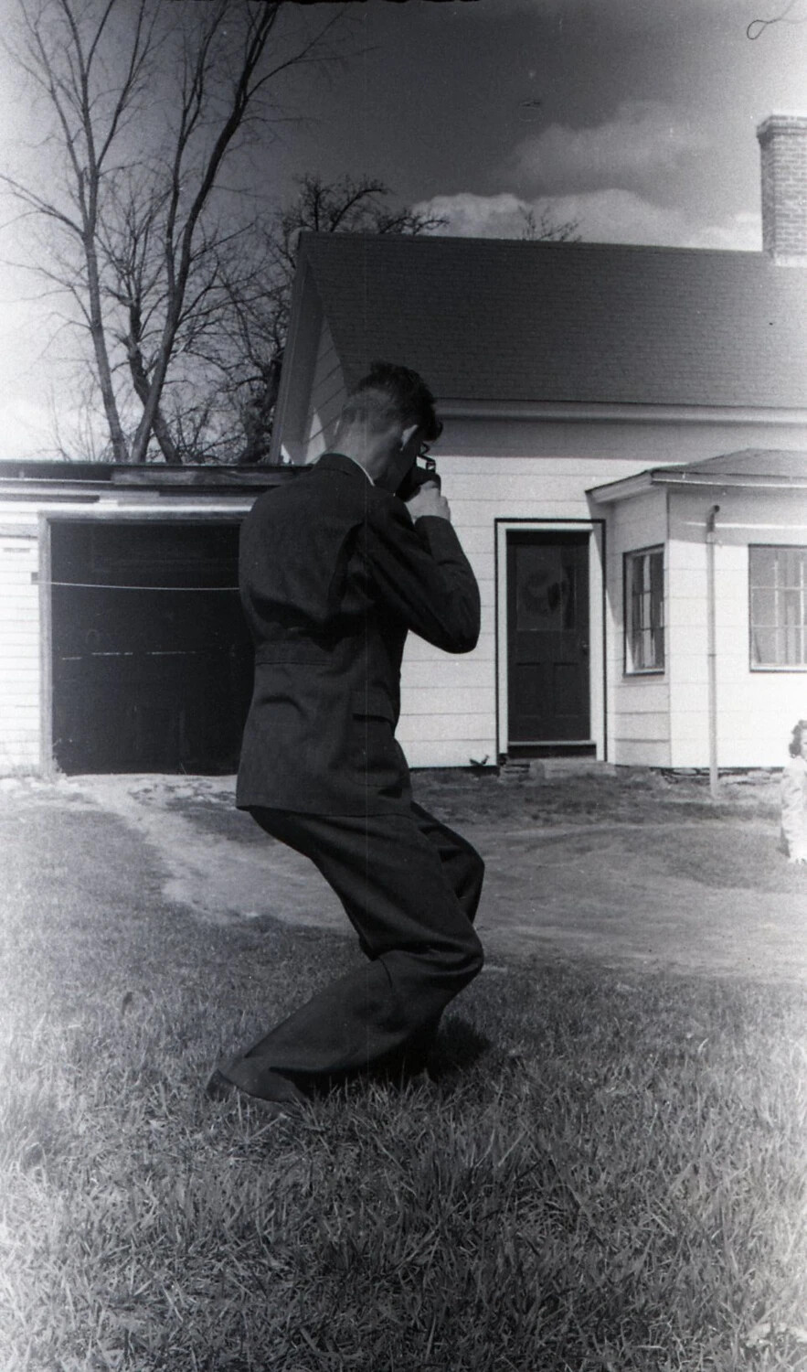 Man Photographing on Residential Lawn, Stateside