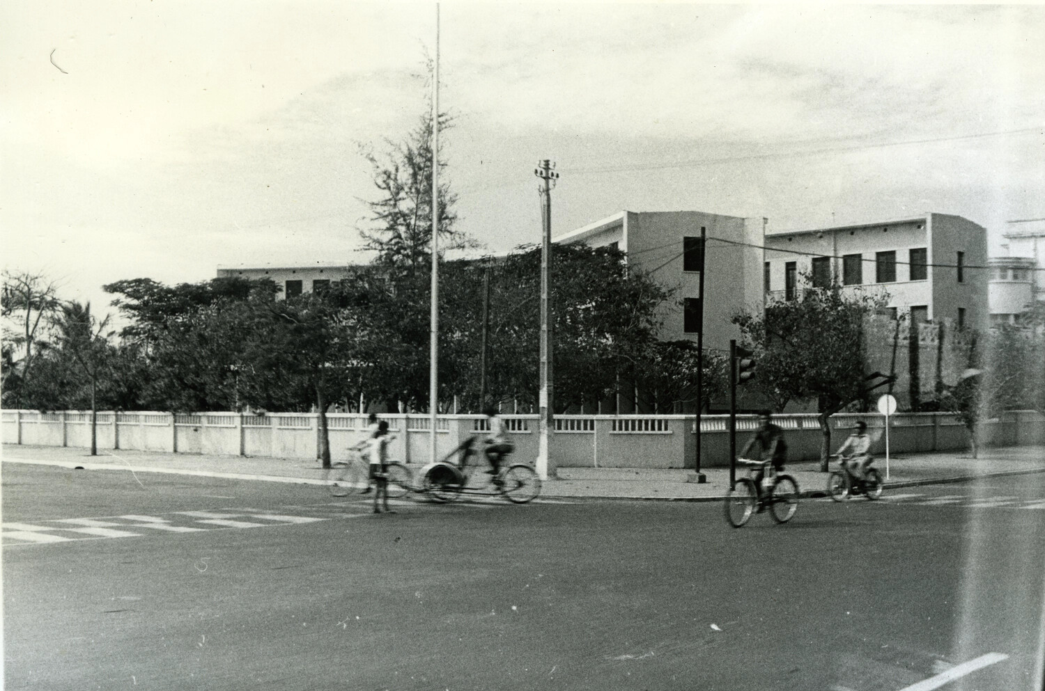 Street Intersection with Cyclists and Cyclo near Institutional Compound, Phnom Penh, Cambodia, c. 1960s
