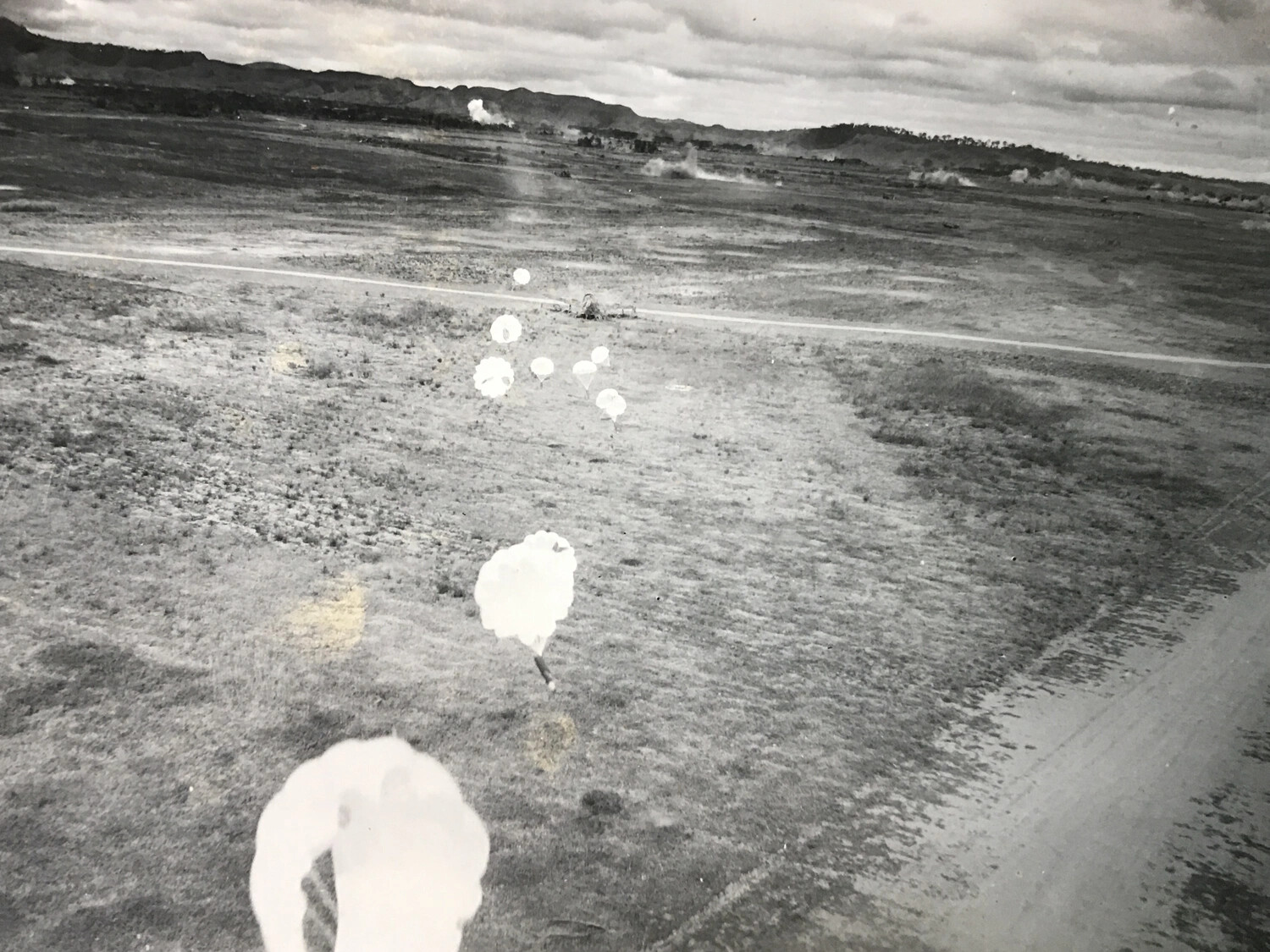 Parachute-Retarded Fragmentation Bombs (Parafrags) Descending Toward Target