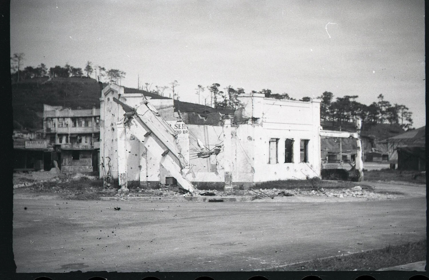Bomb/Shell-Damaged Commercial Building at Street Corner, Luzon, Philippines, WWII