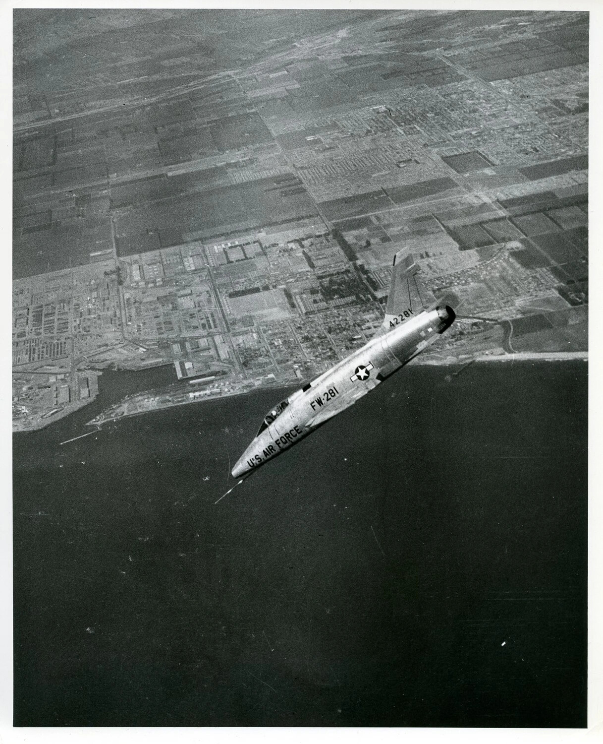 North American F-100 Super Sabre in Banking Turn Over Coastal Airfield