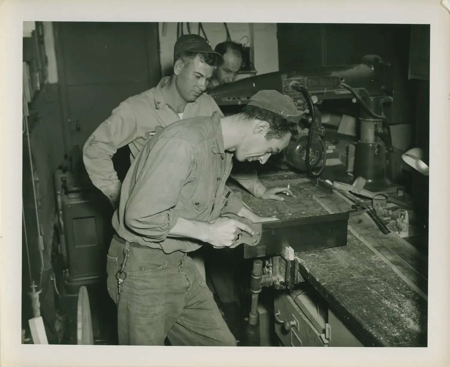 Sailors at Work in the Carpenter Shop Aboard USS Petrof Bay (CVE-80)