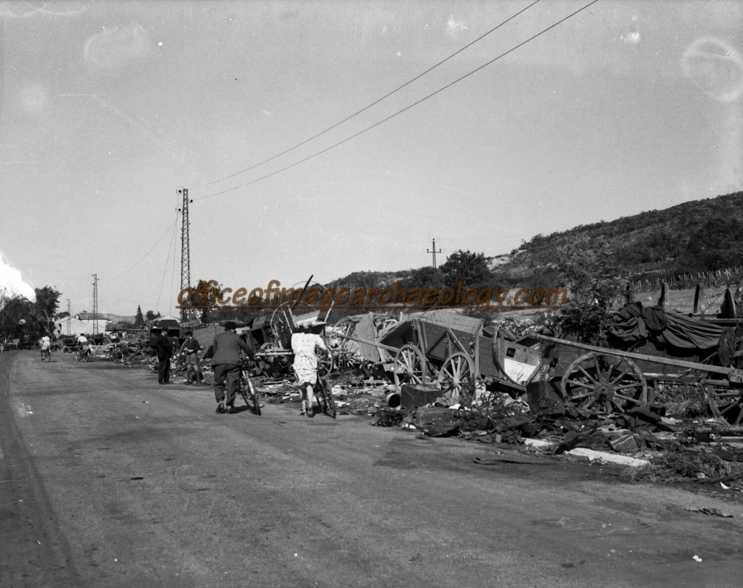 Destroyed Horse-Drawn Wagon Train and Scattered Belongings Along Roadside, Germany, World War II