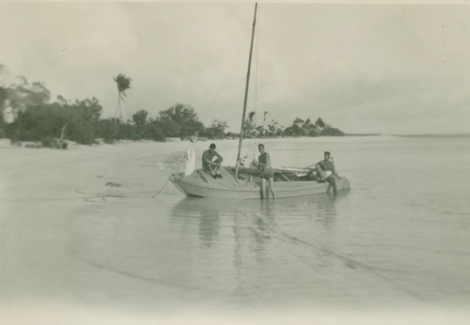 Servicemen with Sailing Skiff on Tropical Lagoon Shoreline, Pacific Theater, WWII Era