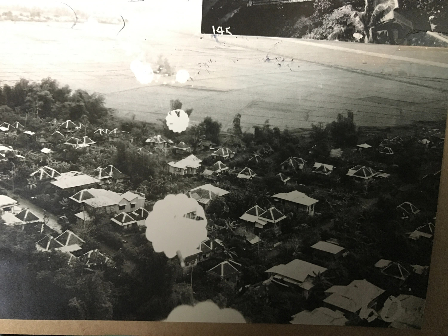 Album View of Low-Level Aerial Strike Photograph Over Pacific Village, Photo No. 145, 312th Bomb Group