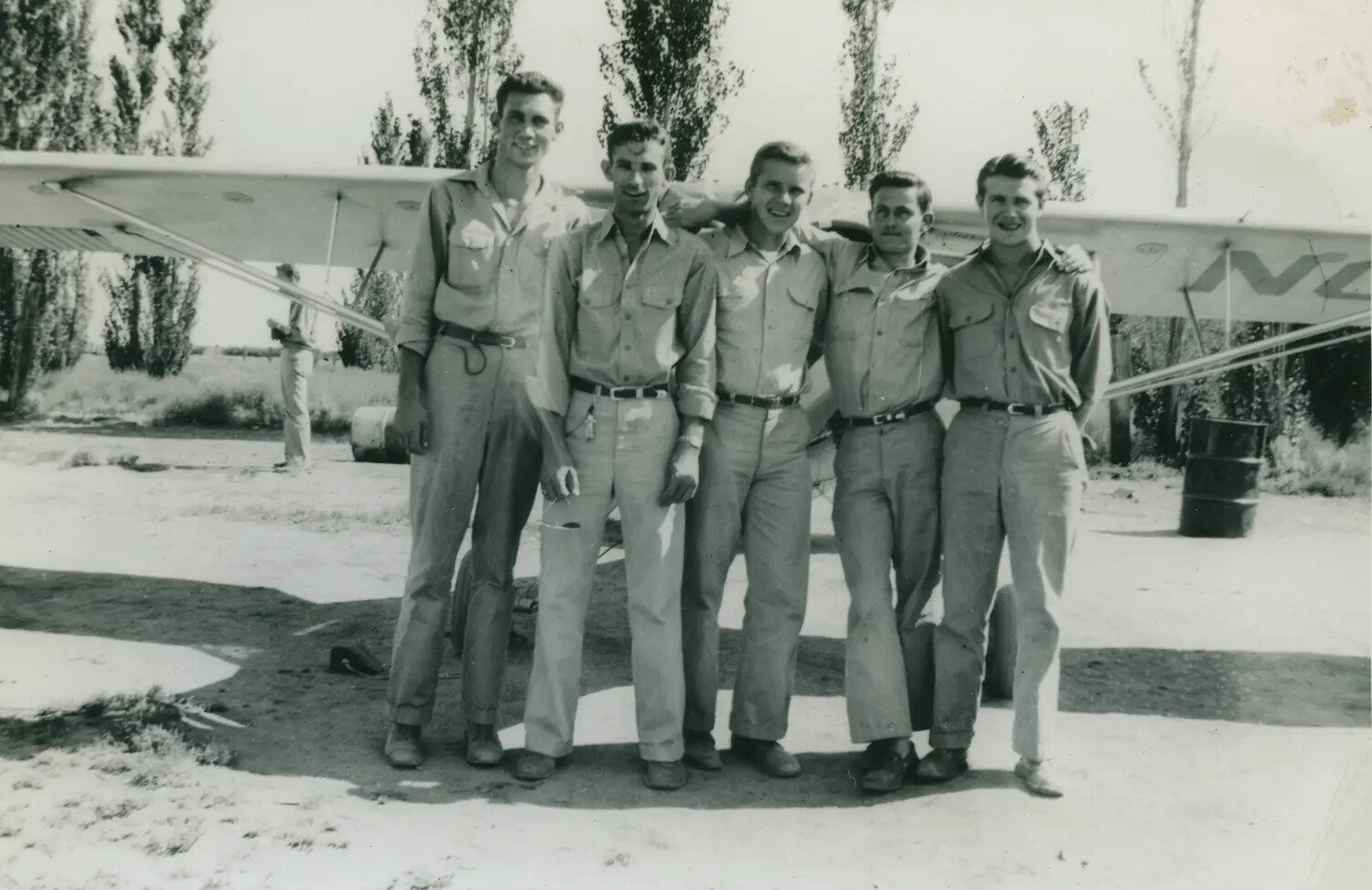 Group Portrait of Five Aviation Cadets Beside a Light Trainer Aircraft, McAleer Collection