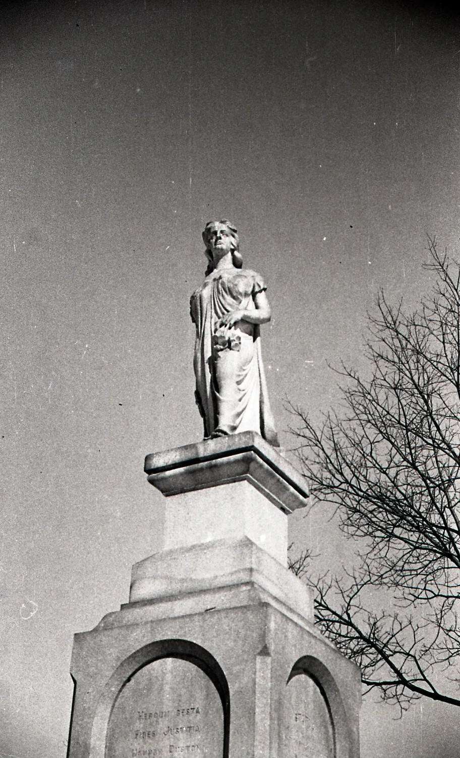Allegorical Statue and Inscribed Pedestal, Low-Angle Winter View