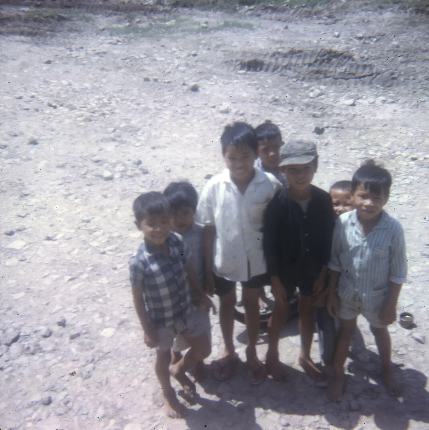 Vietnamese Children Posing Outdoors on Gravel Ground - Vietnam War Era Slide Photograph