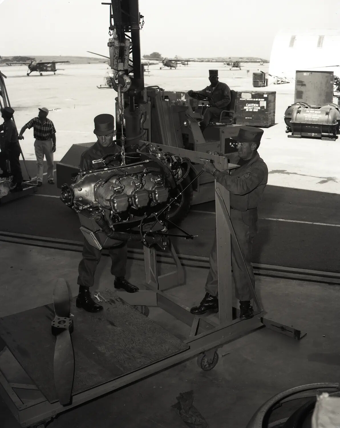 California Army National Guard Maintenance Crew Hoisting Aircraft Engine, Sacramento, 1960