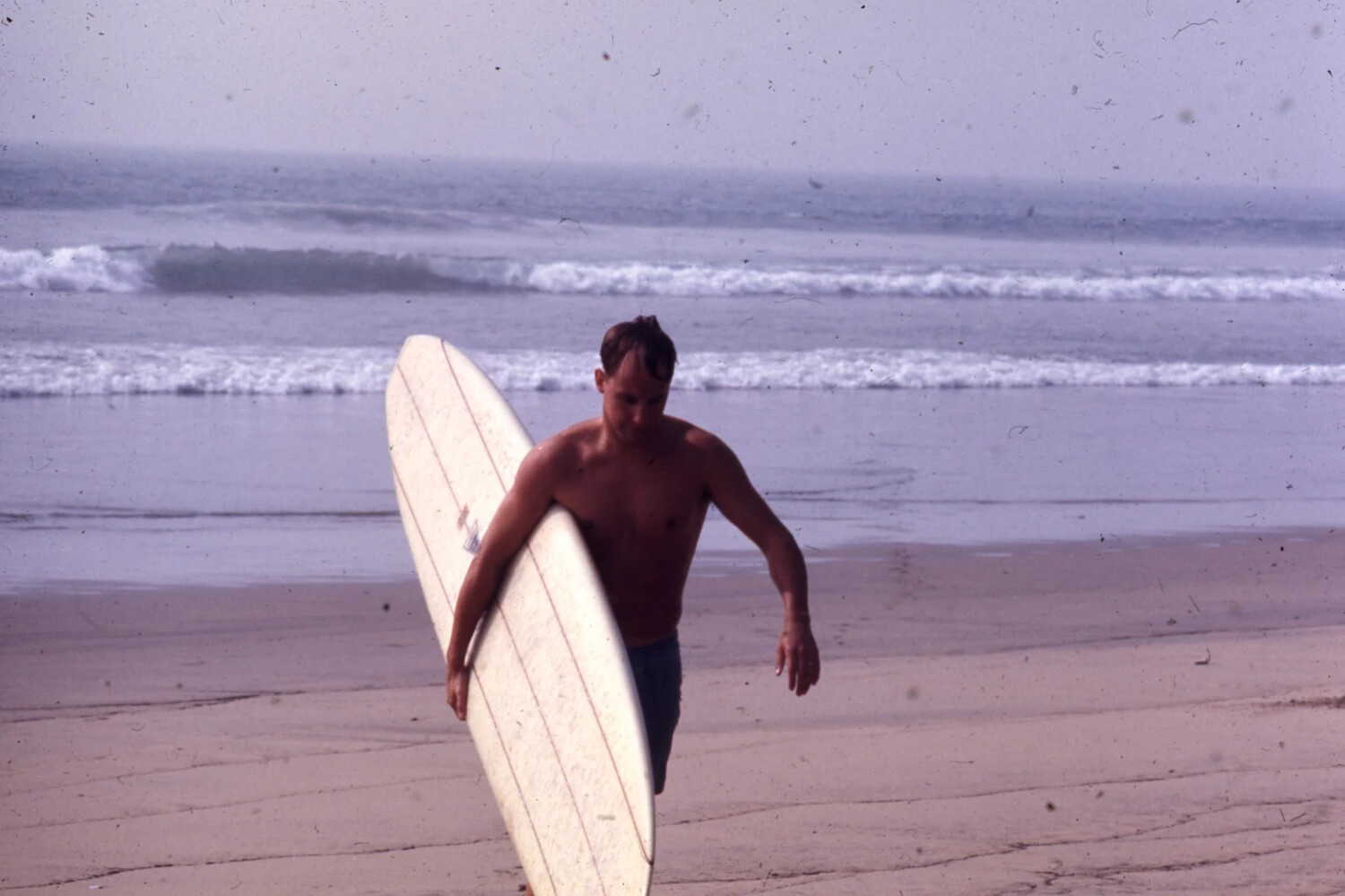 Sailor Carrying Surfboard on Beach, USS Ticonderoga R&R Collection