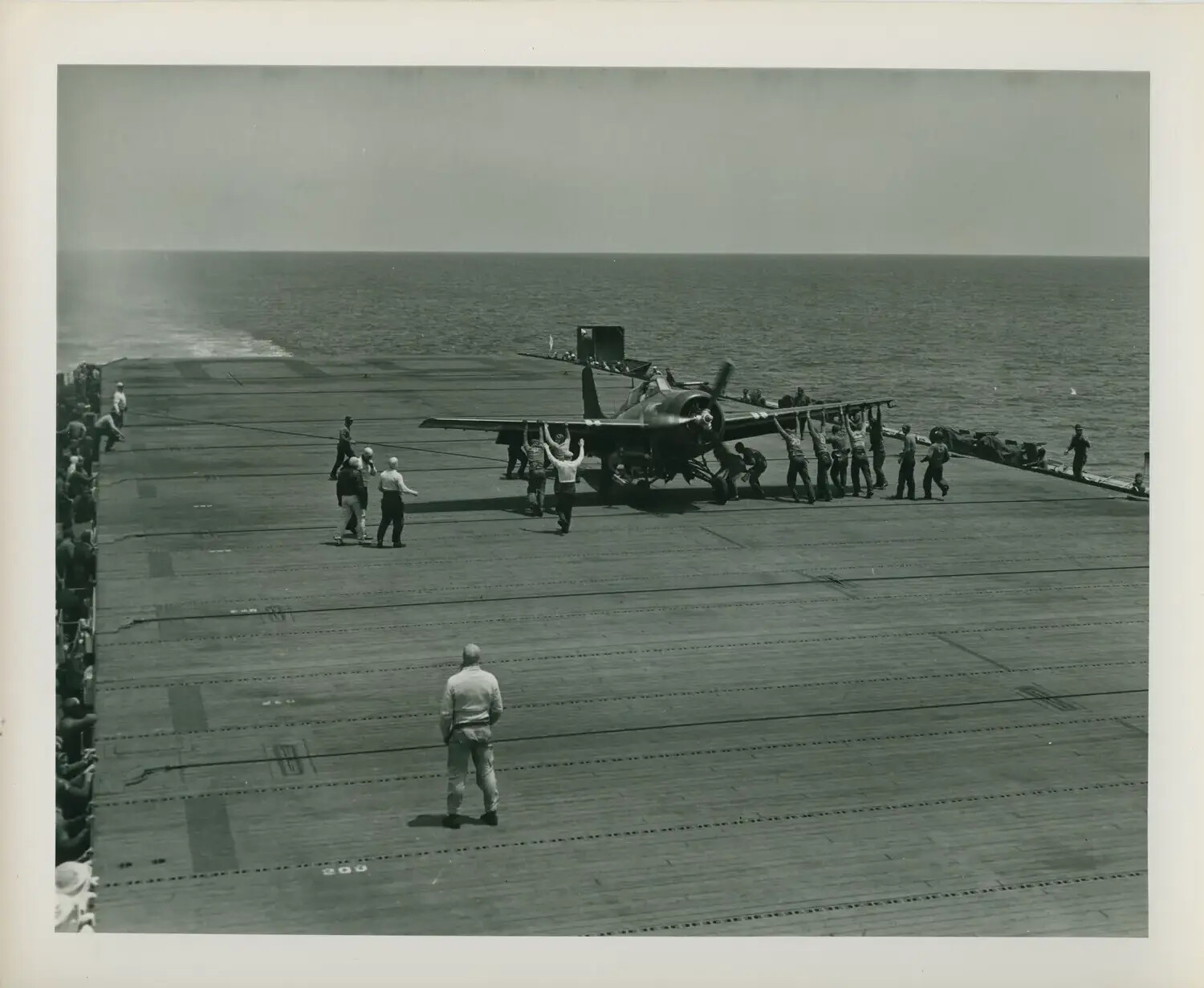 Flight Deck Crew Spotting a Single-Engine Aircraft Aboard USS Petrof Bay (CVE-80), World War II