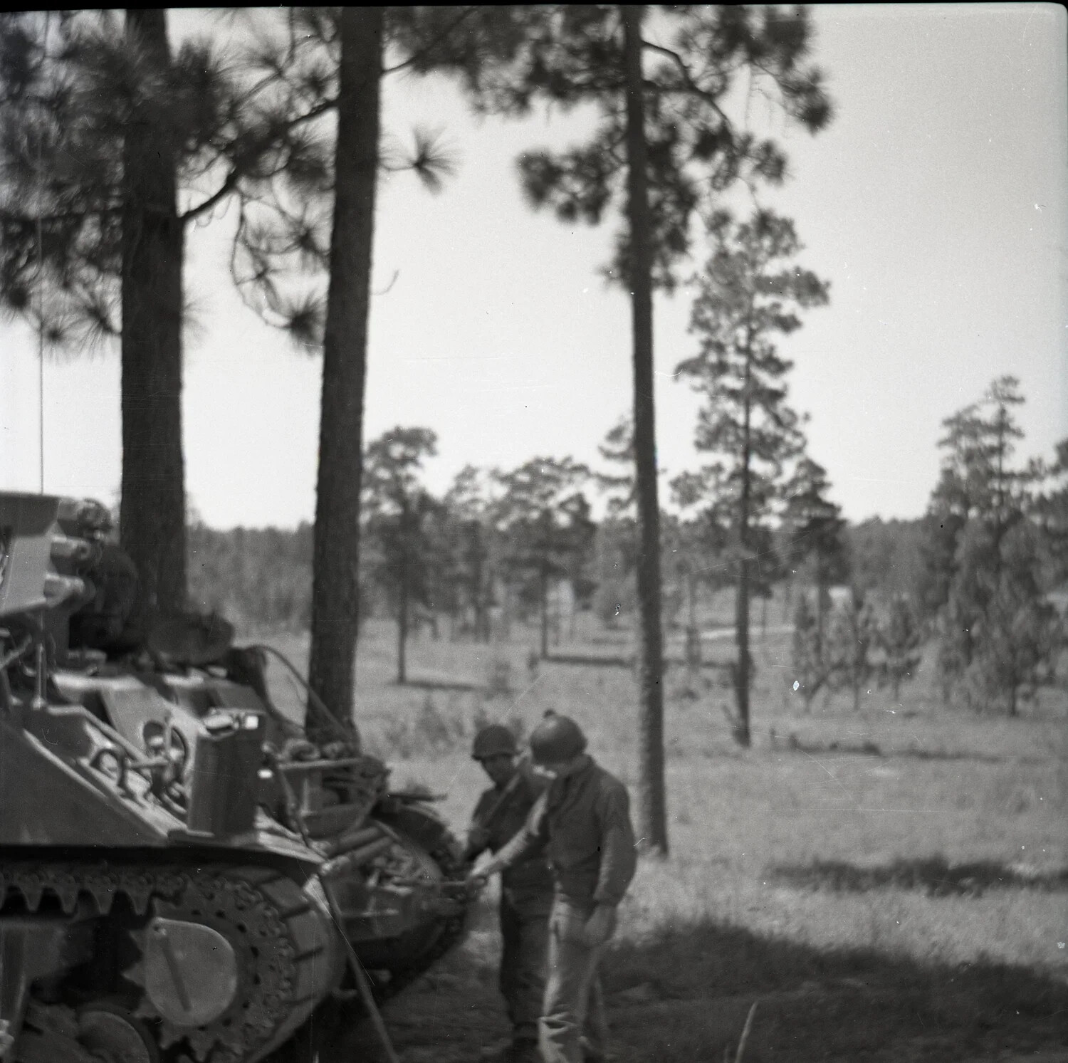 U.S. Army Soldiers Inspecting Tracked Vehicle During Training Exercise, Pine Forest, WWII Era