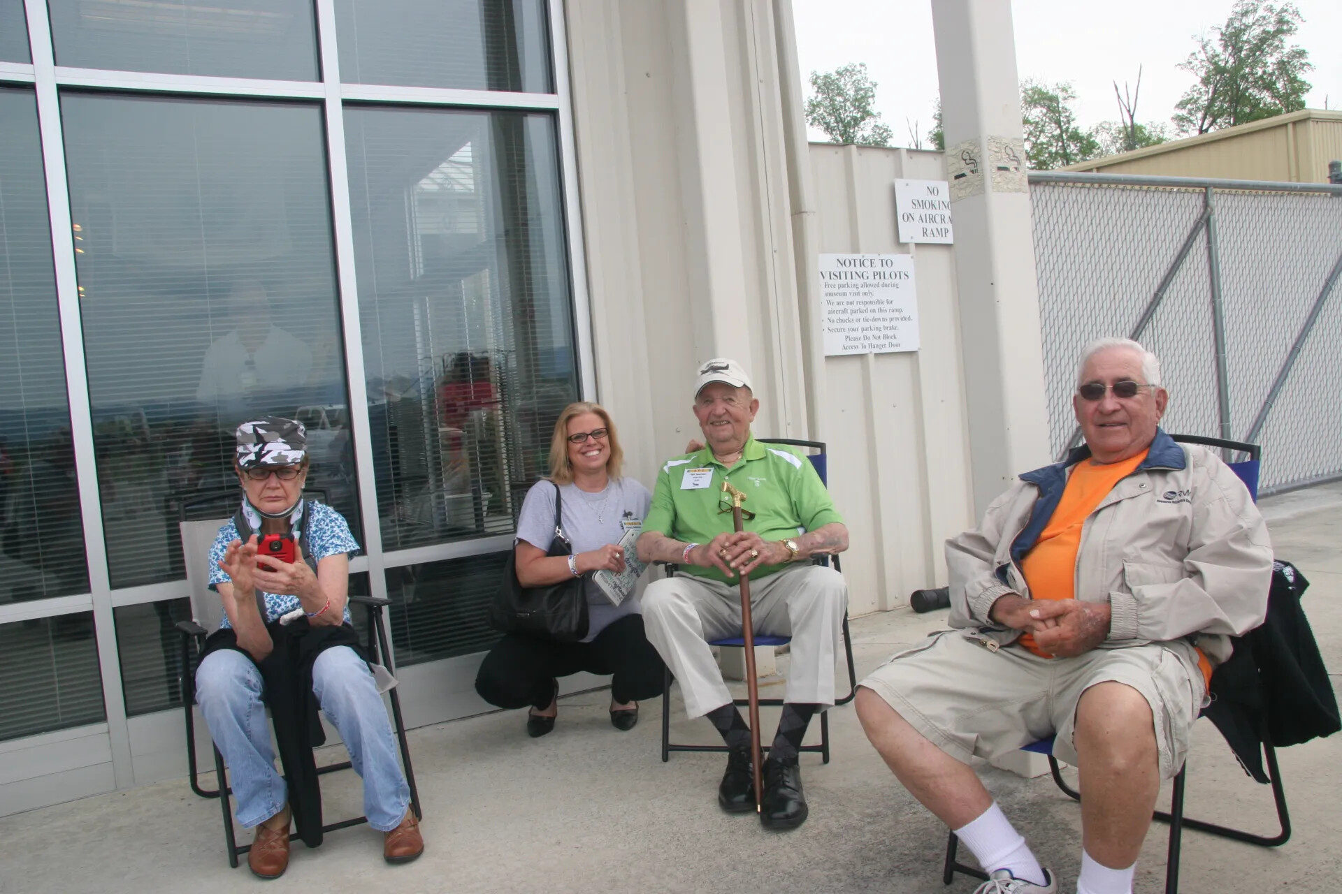 Reunion Attendees Seated Outside Museum Entrance, Second Frame