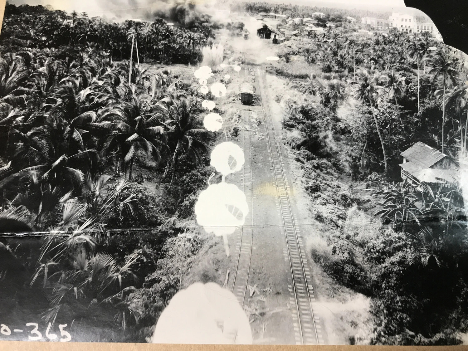 Low-Level Strike Photograph Showing Parafrag Bomb Train Descending on Railway, Philippines, 312th Bomb Group
