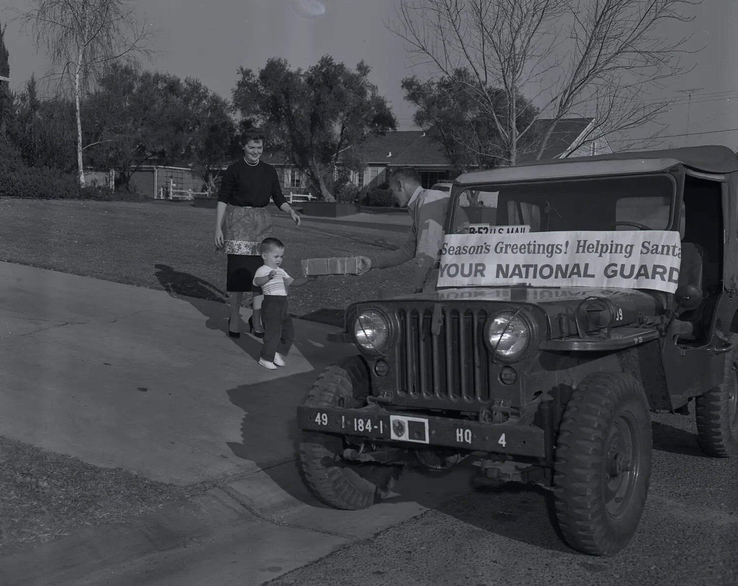National Guard M38A1 Jeep Christmas Toy Delivery, Suburban Residence, c. late 1950s (Frame 2)