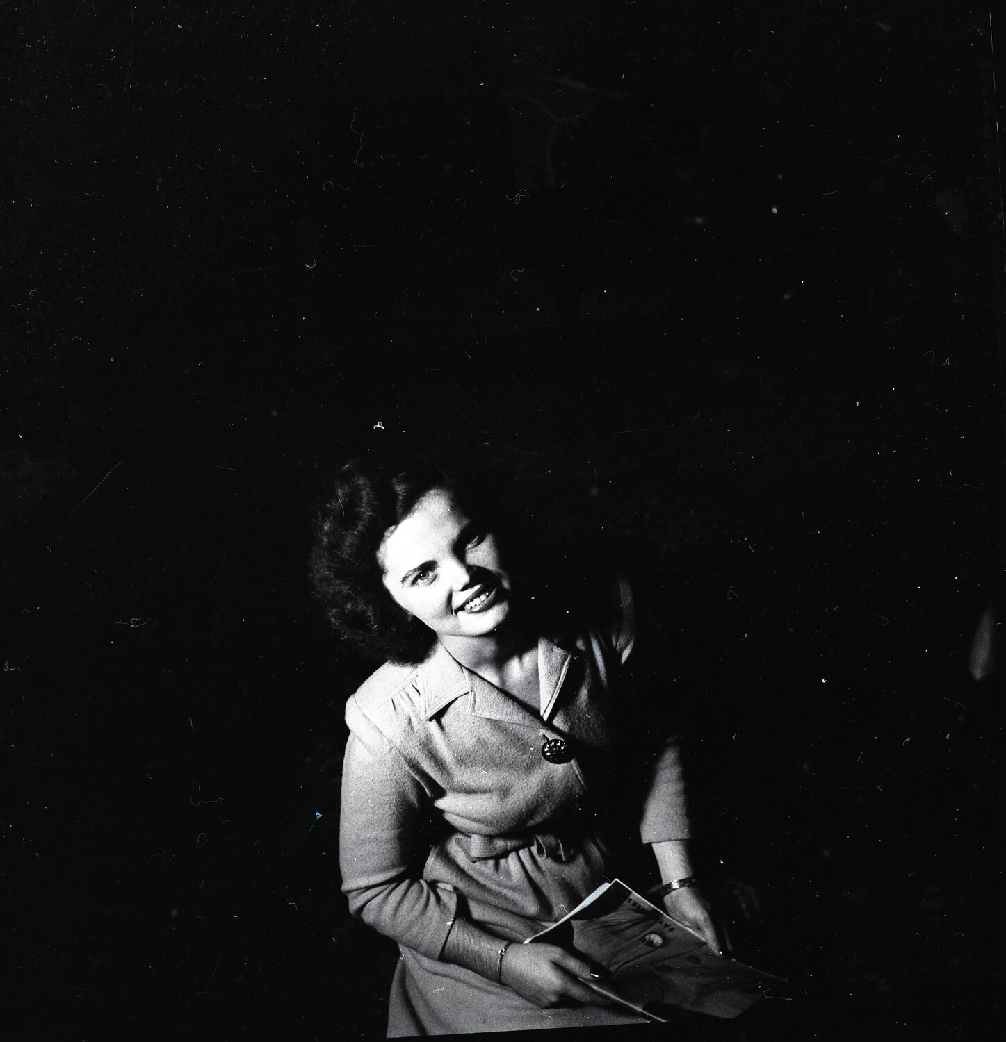 Studio Portrait of a Young Woman Smiling, Holding a Booklet, Wartime Era